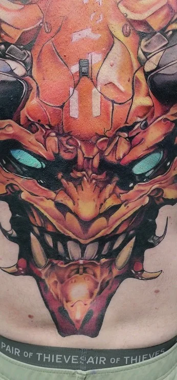 Color demon mask chest tattoo by Allan