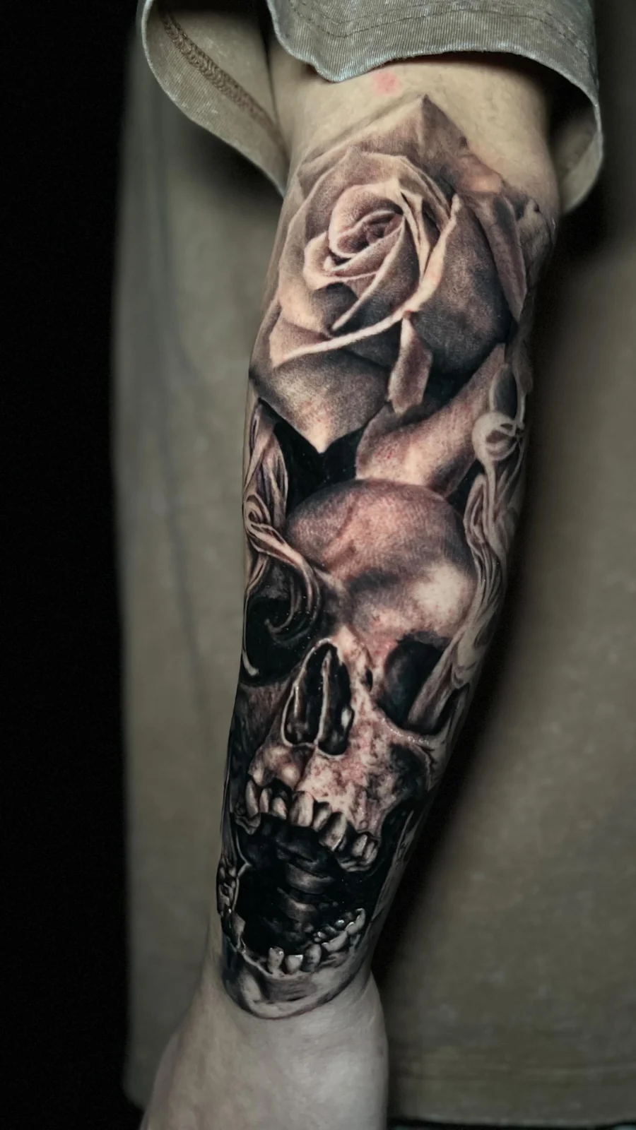 Black and gray skull and rose tattoo by Juan